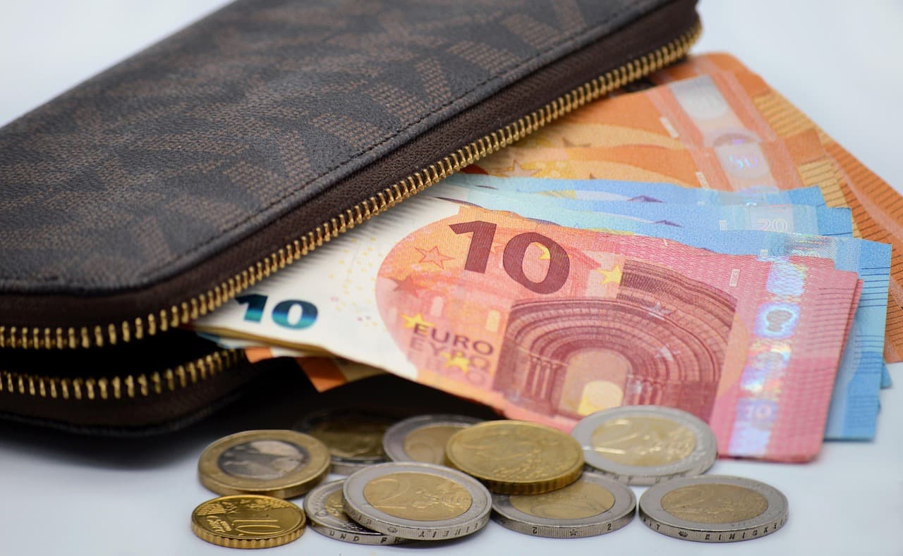A wallet with money spilling out
